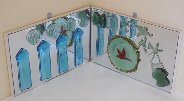Mirrors at a right angle.   Slumped bottle parts and swarf.   Red frit.   For a corner or pedestal.