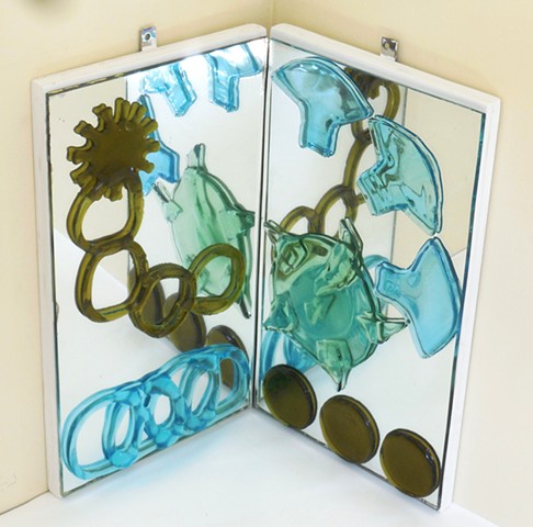 Slumped and fused bottle glass on mirrors that are on hinged plywood.   Hangs in a corner. 