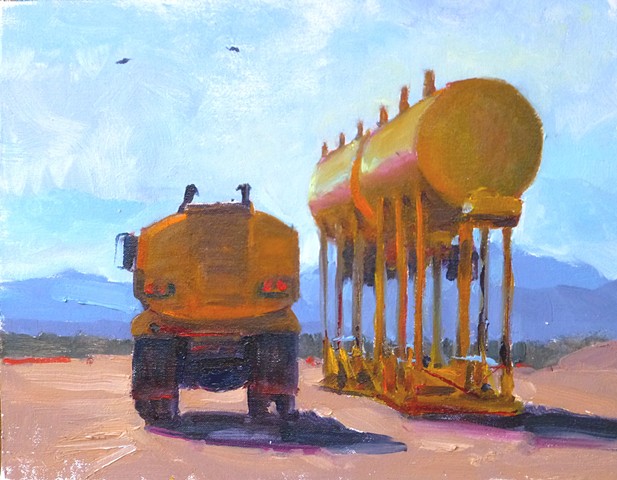 Ass end of a yellow truck, with water tanks