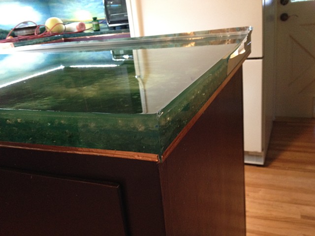 Removed metal tape after the pour and added copper on the bottom edge of the island and counter.