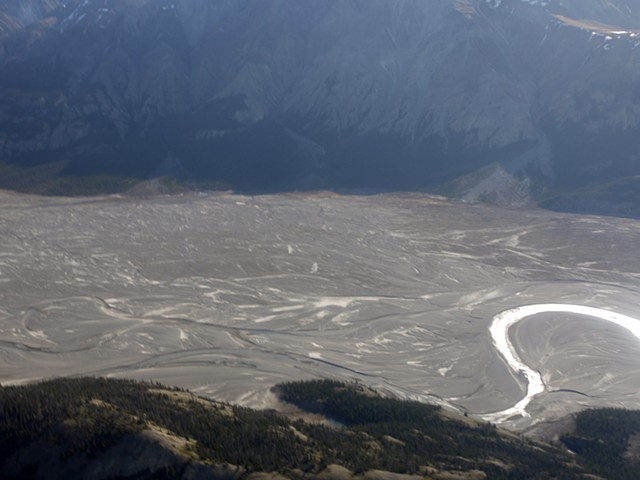 The Kaskawulsh Glacier previously fed the Slims River. In 2016 it retreated so far that it changed course and the river channel is largely empty.
