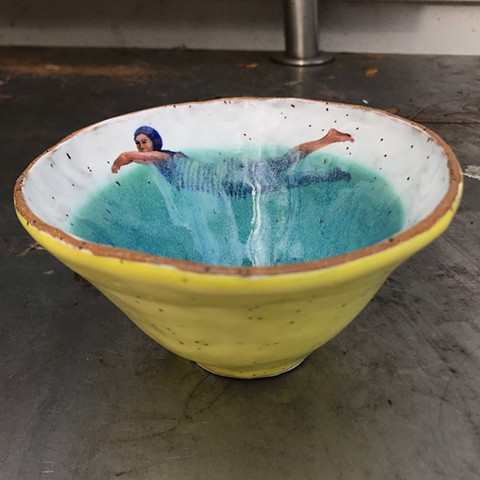 Ceramic, handbuilt bowl with swimmer painted with Aamaco underglaes fired at cone 6.