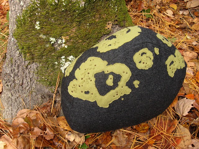 stone shaped wool pillow with hand appliqued and embroidered lichen