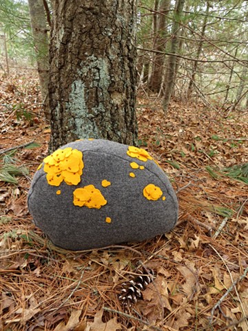 stone shaped wool pillow with yellow wool appliqued and embroidered lichens made by Chelsea Clarke. pillow, stone, rock, stonewall, lichen, moss, yellow, gray, new england