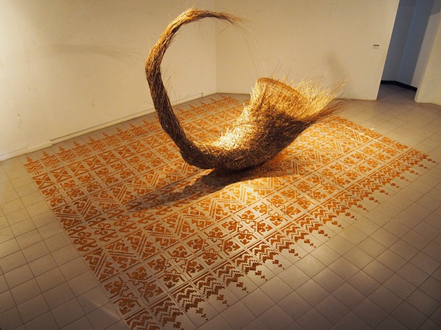 Kang Ya-Chu - Dirt Carpet # 1- The Loop (Thailand), 2014, ready-made daily baskets, bamboo, coconut leaves, wire, dirt. Culture and Social Costs Project- International Art and Design Workshop and Exhibition, Khon Kaen University, Thailand