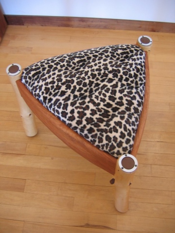 Leopard Ottoman with hand carved Cherry and peeled pine branches with Aluminum and Leather endcaps