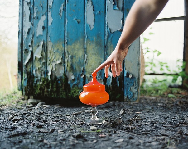 erotic photograph of orange object fingertip hand blue door nature by Robyn LeRoy-Evans