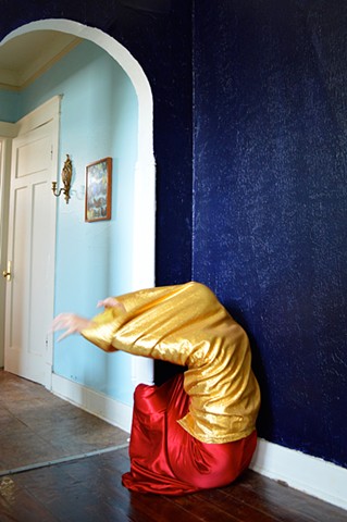 photograph of woman gold red clothing faceless figure house New Orleans by Robyn LeRoy-Evans