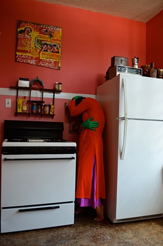 photograph of woman dress kitchen bright colours scared domestic by Robyn LeRoy-Evans