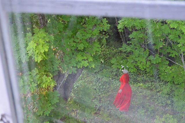photograph of woman red dress green forrest window by Robyn LeRoy-Evans