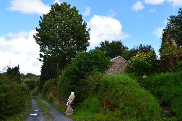photograph of woman white cream dress trees blue sky in Wales by Robyn LeRoy-Evans