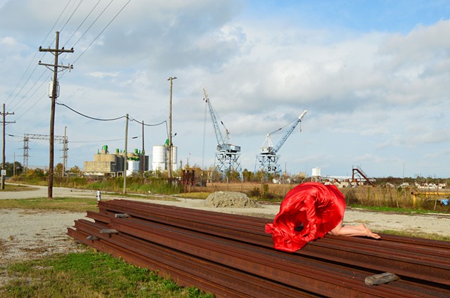 photograph of woman red drapery industrial landscape in New Orleans by Robyn LeRoy-Evans