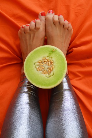 photograph of woman feet legs toes honeydew melon food silver leggings fetish by Robyn LeRoy-Evans