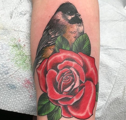 Bird tattoo with a traditional rose in colour Strange World Tattoo Calgary 