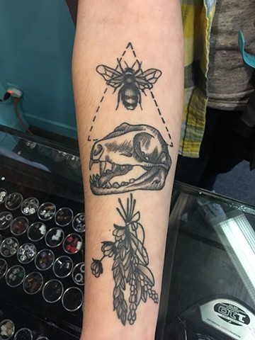 black and grey dinosaur, bee and flower tattoo