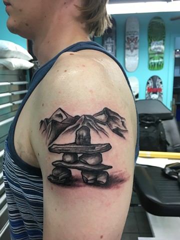 Inukshuk and mountains tattoo
