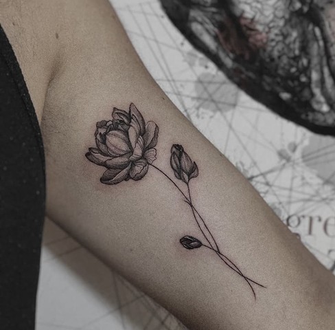 beautiful black and grey flower on inner bicep Strange World Tattoos Calgary tattoos