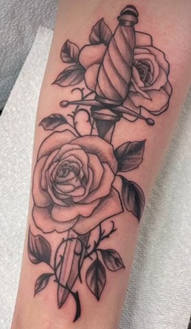 Black and grey rose and dagger tattoo Calgary tattoos strange world tattoo 