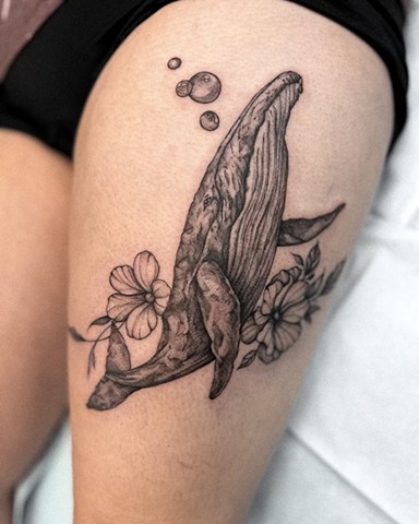Strange world tattoo Calgary alberta Canada Valeriia Ukrainian artist black and grey sketchy illustrative style blue whale blowing bubble with some hibiscus type flowers on either side on the thigh swimming upward soft feminine dainty 