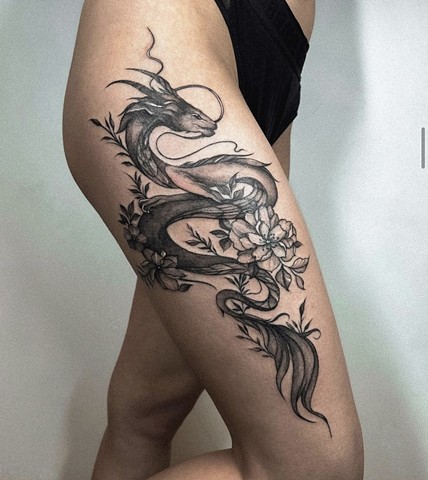 large dragon tattoo on upper thigh Strange World Tattoo Calgary 