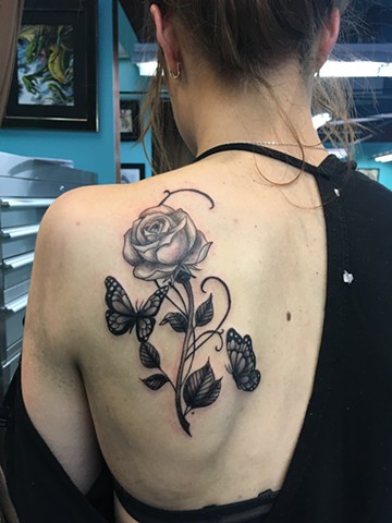 black and grey rose and butterfly tattoo calgary