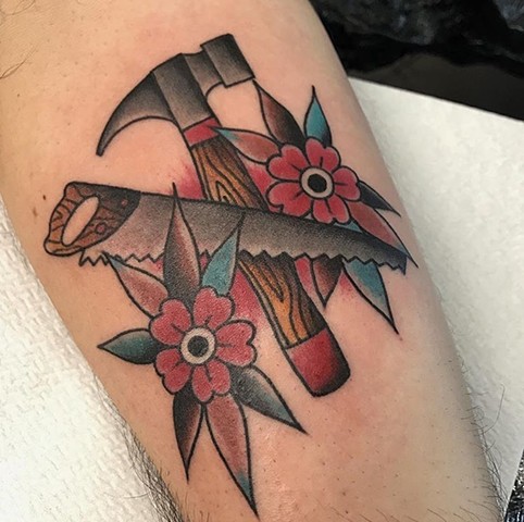 Hammer and saw tattoo in traditional style colour strange World Tattoo Calgary Alberta Canada 