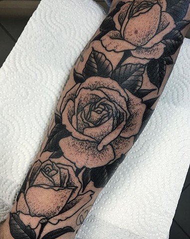 Black and grey roses with dotwork shading on forearm Strange World Tattoo Calgary Alberta Canada 