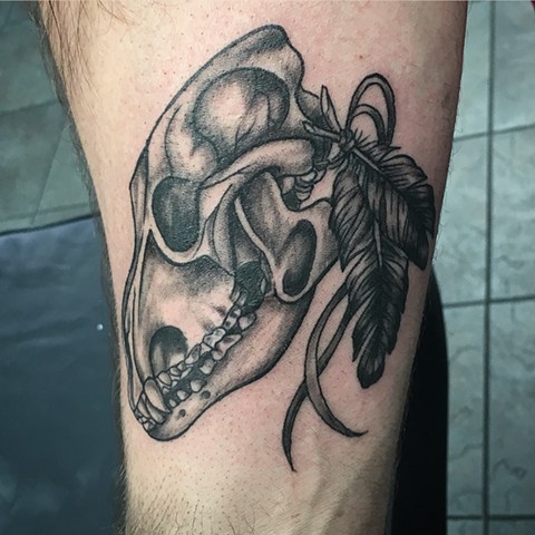 black and grey skull and feather tattoo by Kristin of Strange World Tattoo in Calgary