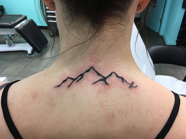 Black mountains with an initial by Kristin of Strange World Tattoo 