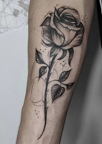 rose tattoo in black and grey in Calgary Alberta Canada Strange World Tattoo