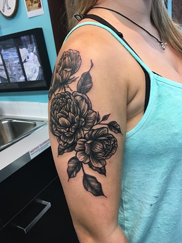 black and grey flower tattoo at Strange World Tattoo in Calgary, Alberta