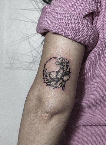 black and grey flower wreath tattoo on upper arm Strange World Tattoo Calgary, Alberta Canada