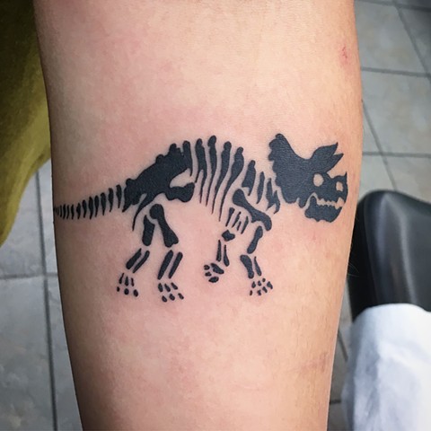 dinosaur skeleton tattoo calgary, alberta