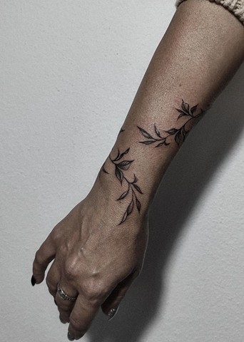 botanical vine wrap tattoo on forearm/wrist Calgary tattoos Strange World Tattoo 