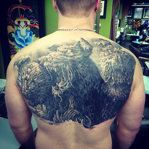 Black and grey upper back tattoo