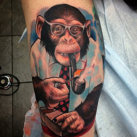 Colour tattoo of monkey smoking a pipe wearing a shirt and tie by Tattoo artist Brett Schwindt of Strange World Tattoo in Calgary
