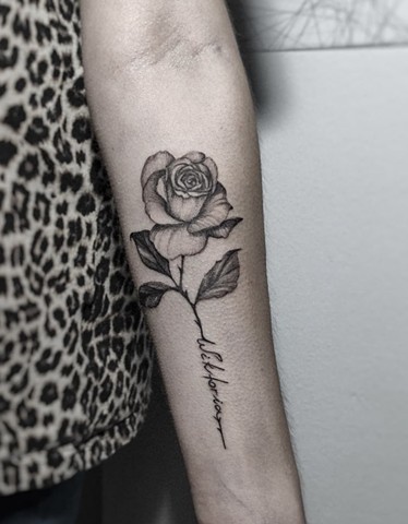 Rose tattoo with script in stem Calgary tattoos Strange World Tattoo 