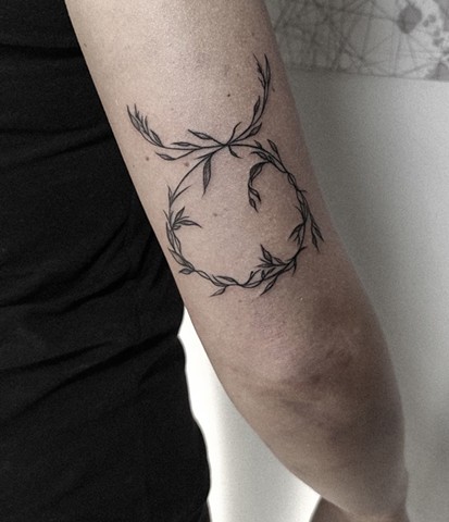 vine wreath tattoo on back of arm Calgary tattoos Strange World Tattoo 