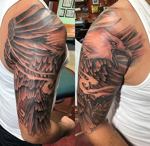 Eagle half sleeve tattoo in black and grey Strange World Tattoo Calgary Alberta Canada 