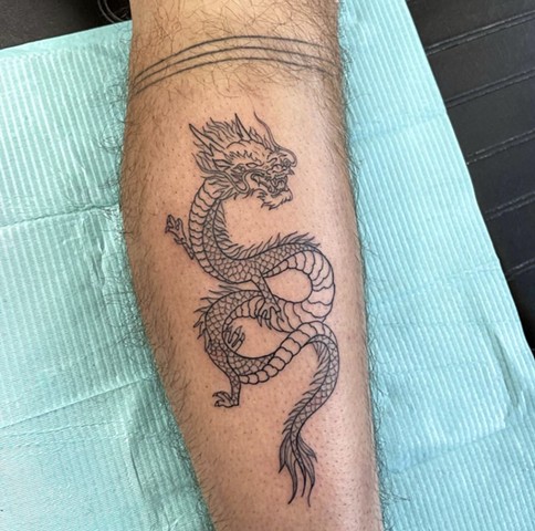 Fineline linework Asian dragon on leg calf tattoo shop artist strange world tattoo Calgary alberta Canada feminine girly dainty 