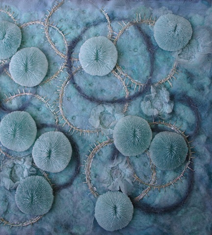 wool and silk embroidered wall hanging with cast resin embellishments