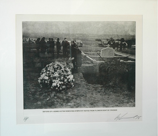 Les Levine 

[Sisters of a bomb victim removing sympathy notes from flowers sent by friends] 