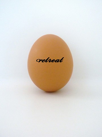 Eggs printed with text, referencing the idea of an egg as a place of retreat and refuge. Sculpture by artist Darren Jones