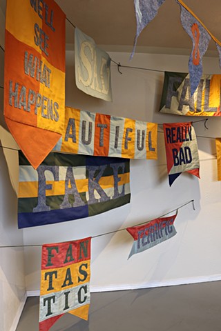 fiber art activist art trump language banners pennants bunting installation art