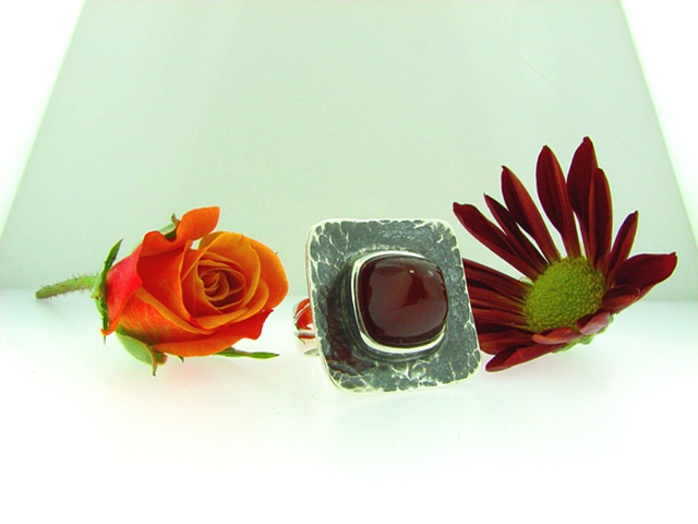 Large sterling silver ring with custom cut Carnelian Bullet cab. + oxidized forged plaque.