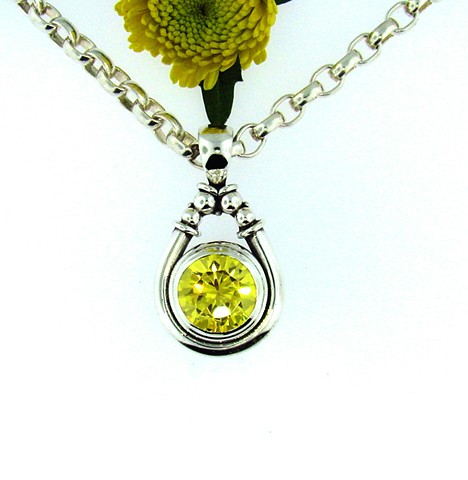 Sterling silver pendant with 12mm round yellow cz. 18in. fox-tail chain.