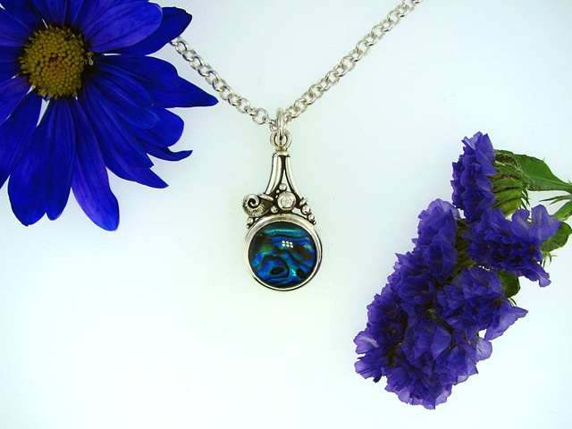 Sterling silver pendant containing a 16mm round Blue Paua Shell and a 2.5mm cz accent.