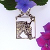 Sterling Silver equestrian themed pendant . Hand carved horse profile with a 2.5mm cz accent. Attached Chain.