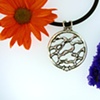 Sterling Silver freeform hand carved pendant with 2.5mm CZ accent + 18in. heavy-duty rubber cord.
