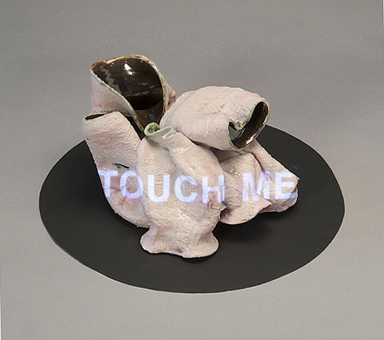 Wheel thrown and altered ceramic vessels with projected text "Touch Me" by Linda S Fitz Gibbon